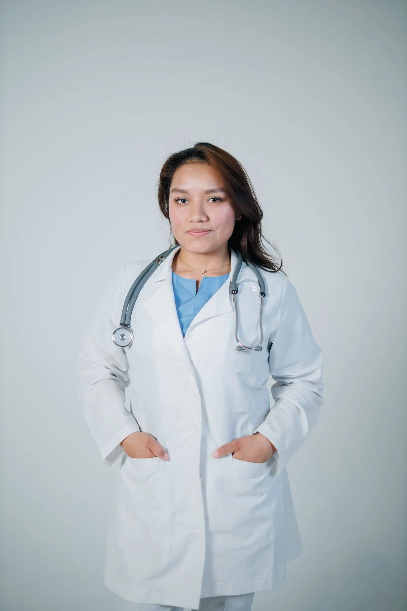 A surgeon photographed against a plain neutral background.