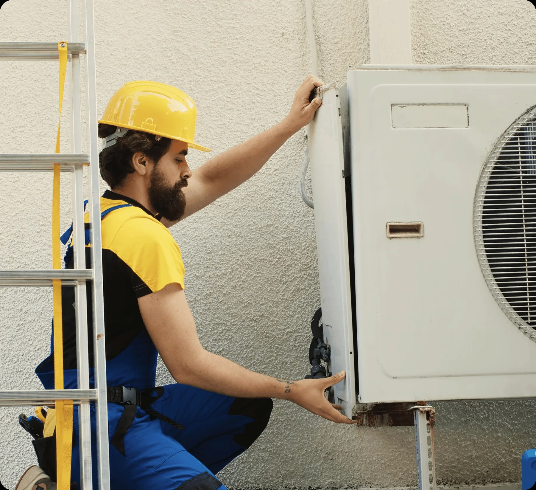 A technician on a ladder at an outdoor unit.