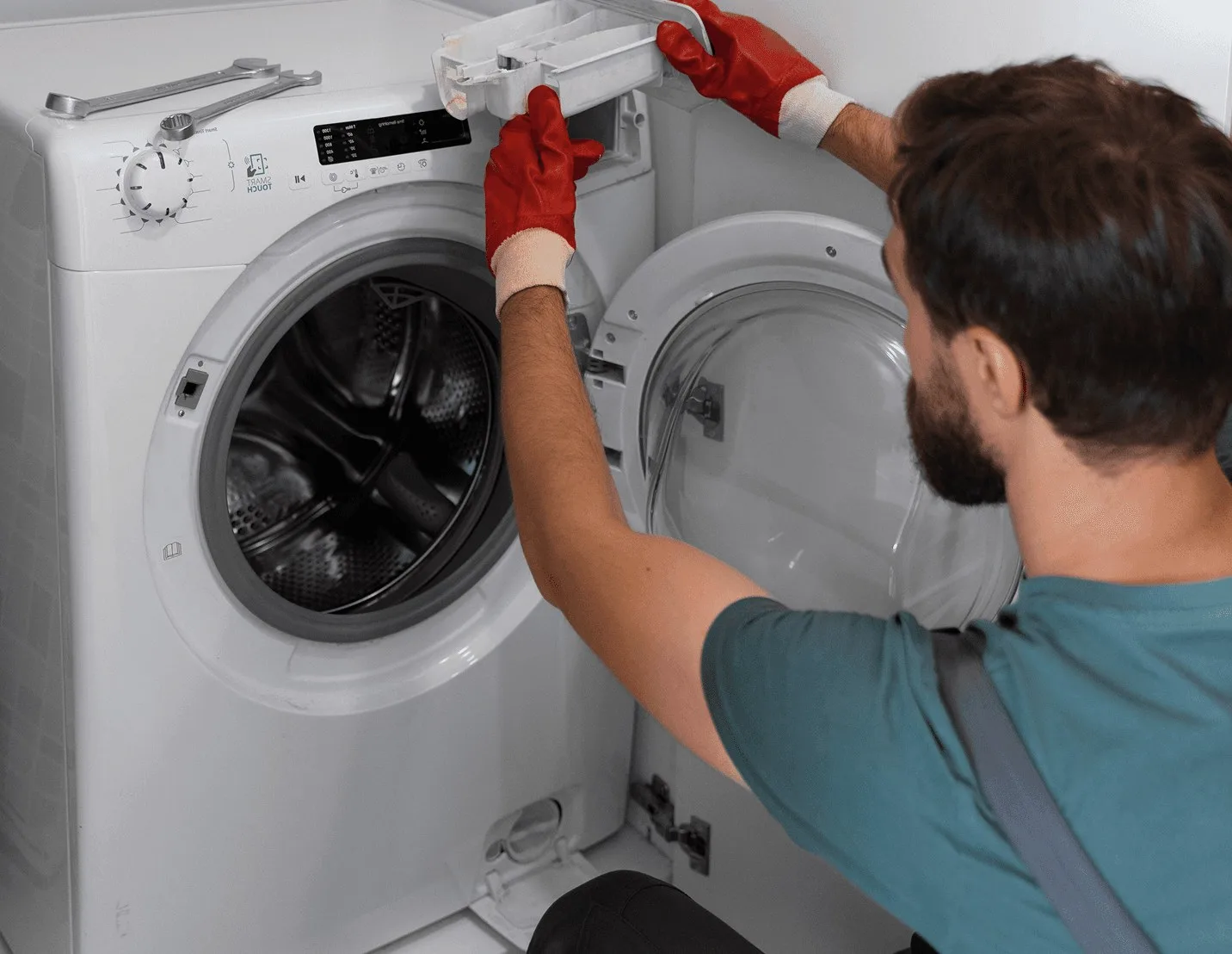 A technician working on a washing machine.