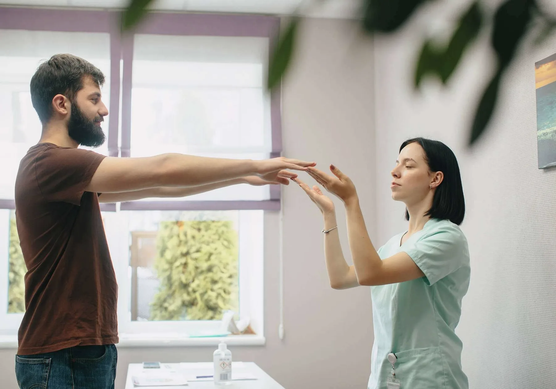 A physiotherapist guiding a patient's arms.