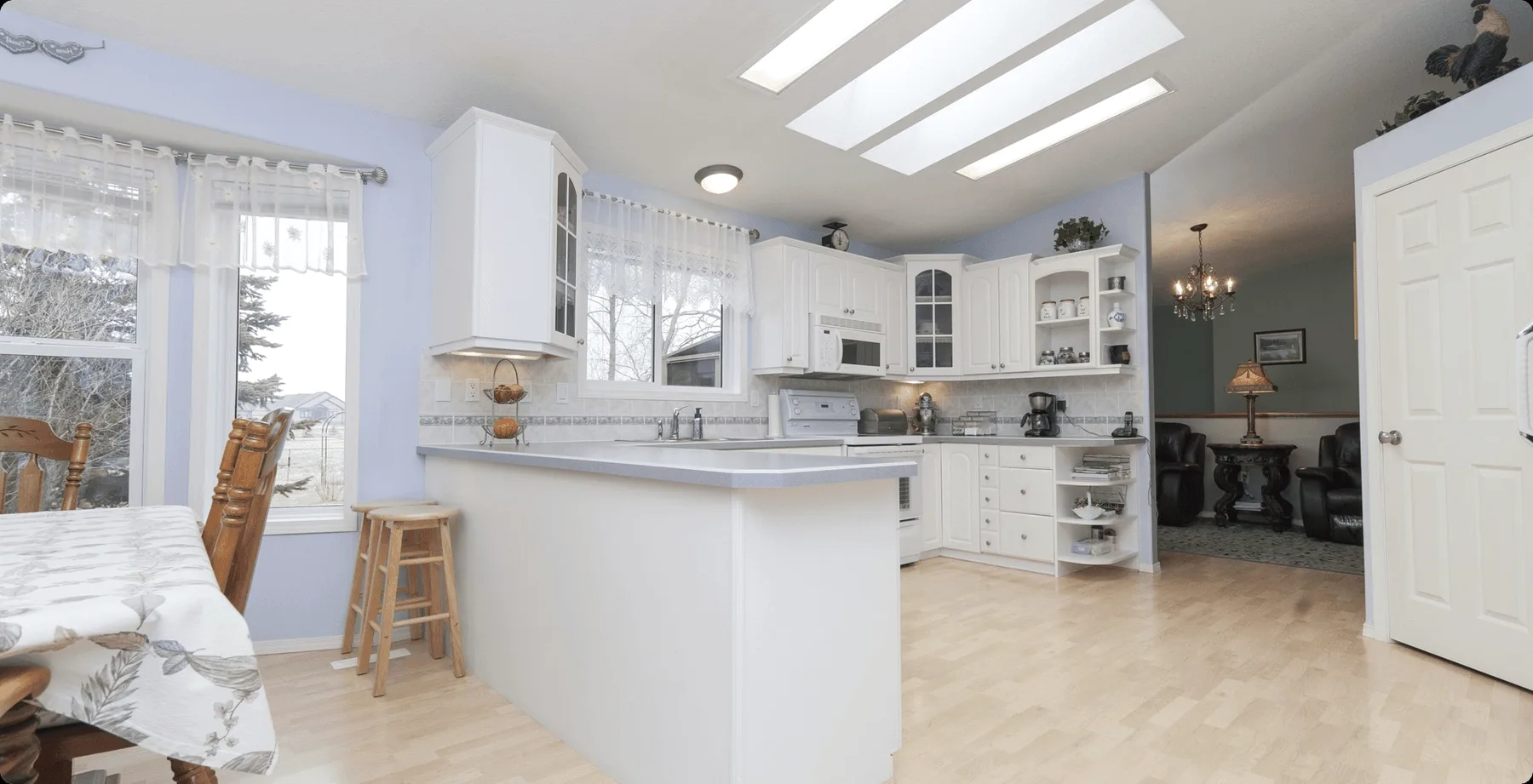 A white kitchen with skylights.