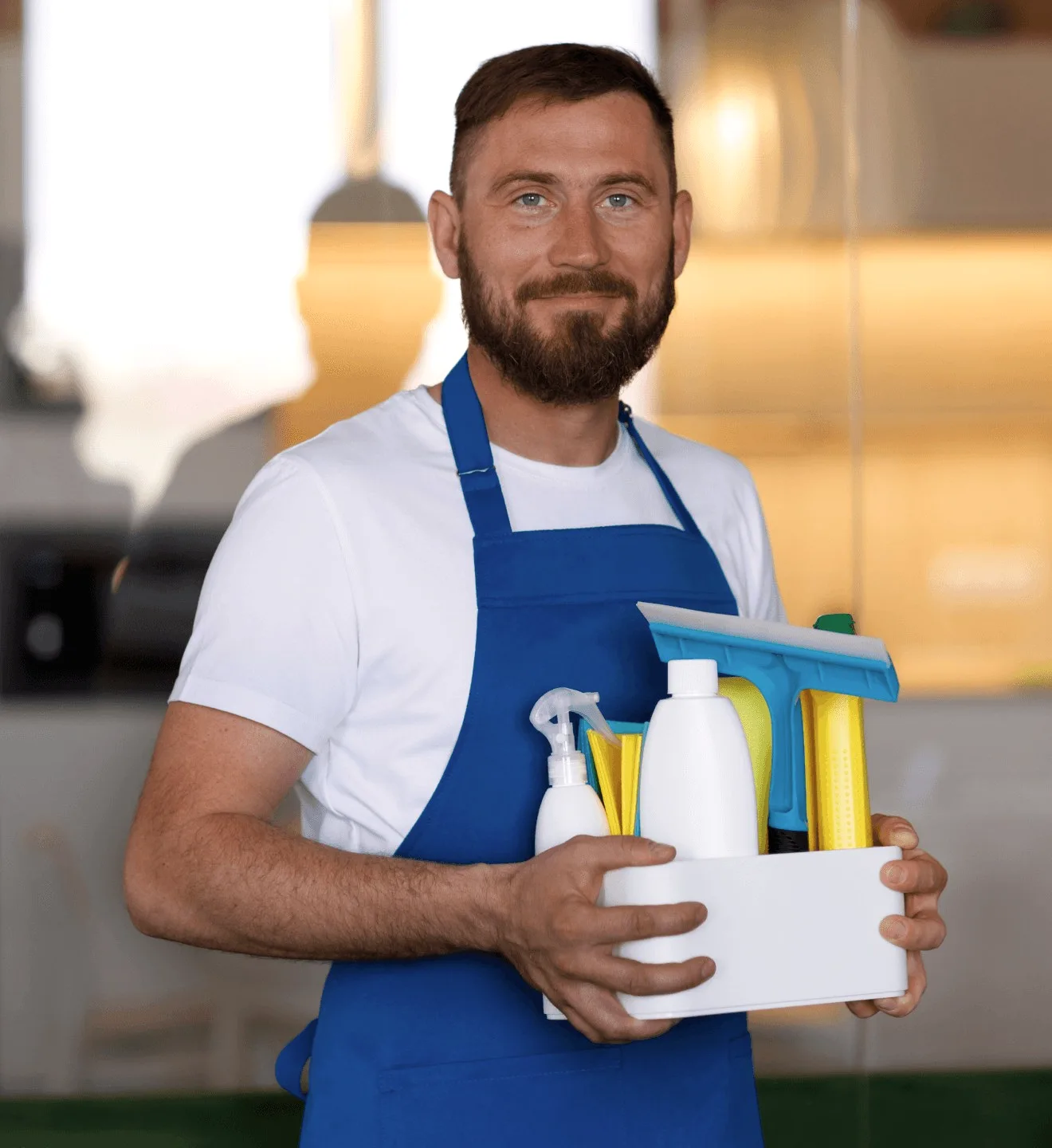 A cleaner in a blue apron holding a caddy of bottles.