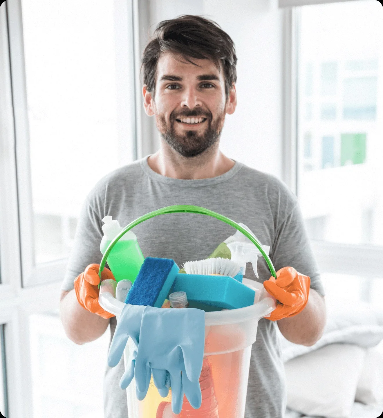 A cleaner holding a bucket of cleaning supplies.