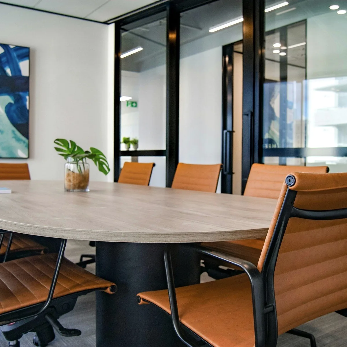 An empty meeting room with leather chairs.