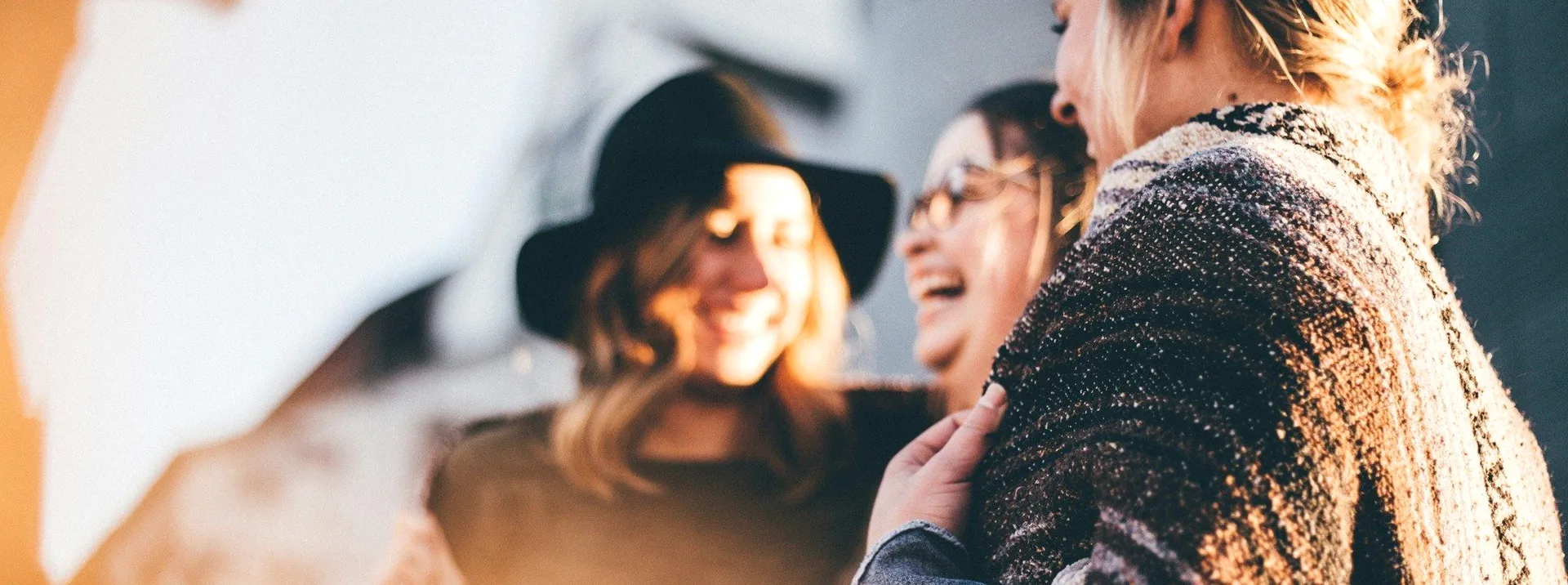 Two women laughing in the sun.