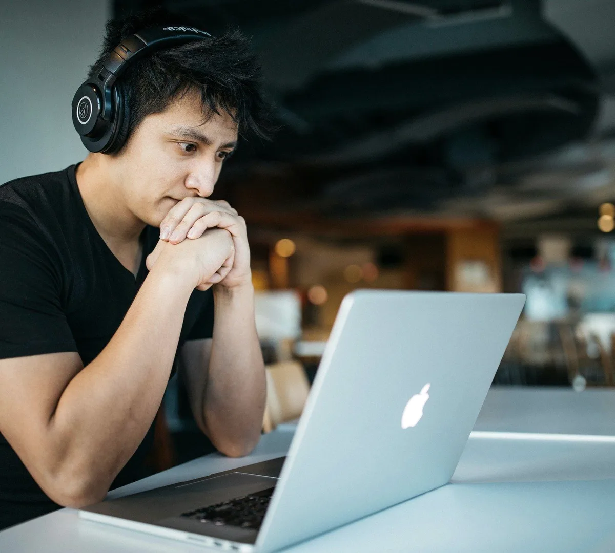A man in headphones at a laptop.