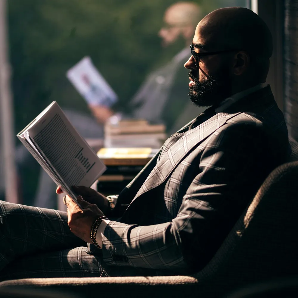 A man reading in a dark room.