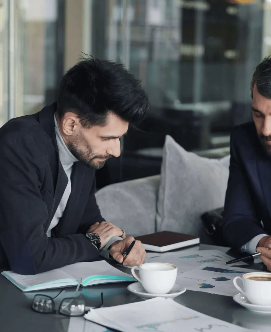Two men at a laptop.