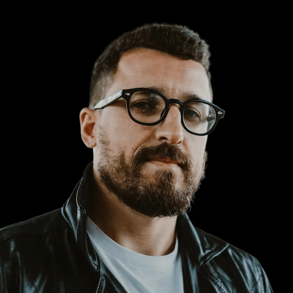 A bearded man in glasses.