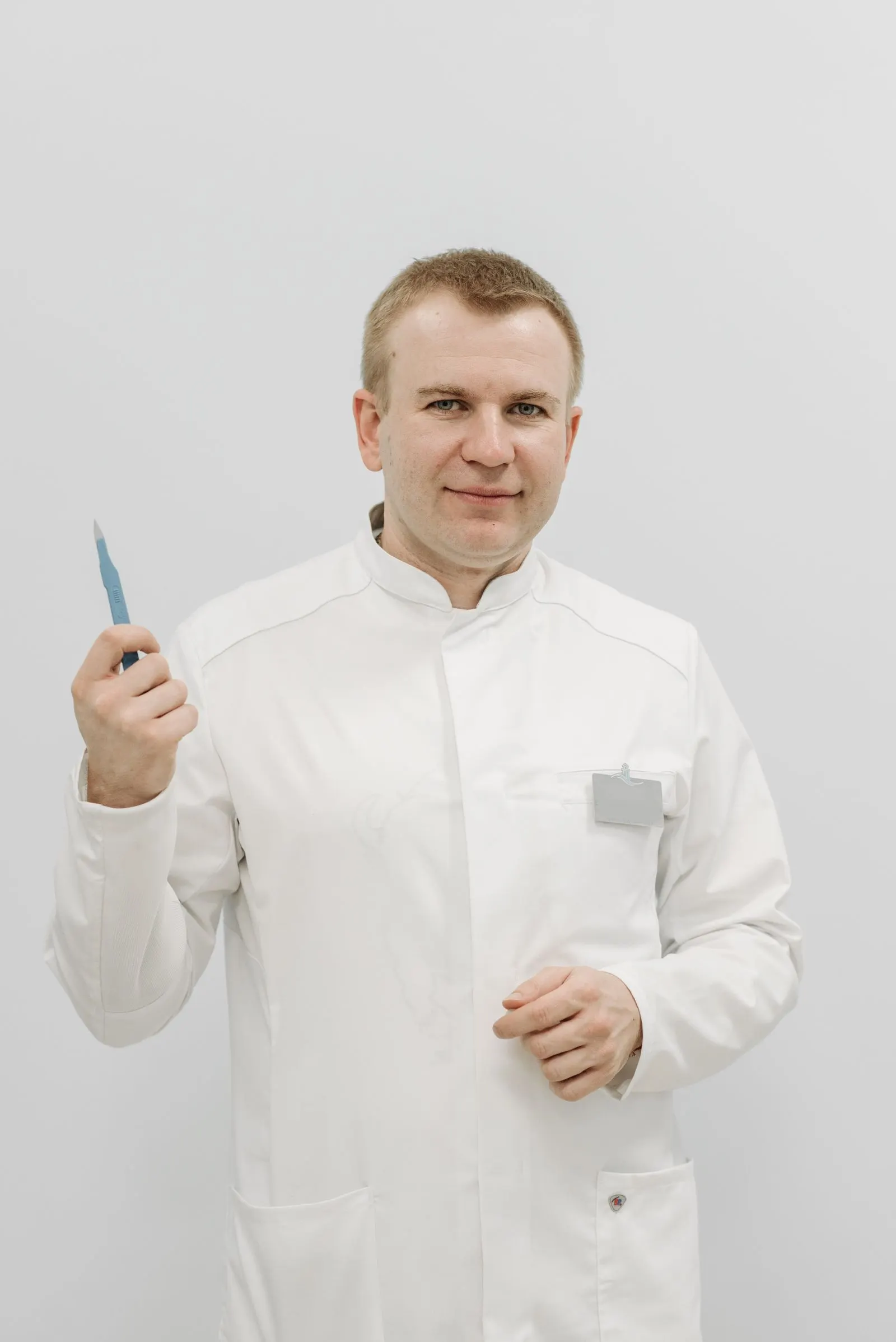 A dermatologist photographed against a plain background.