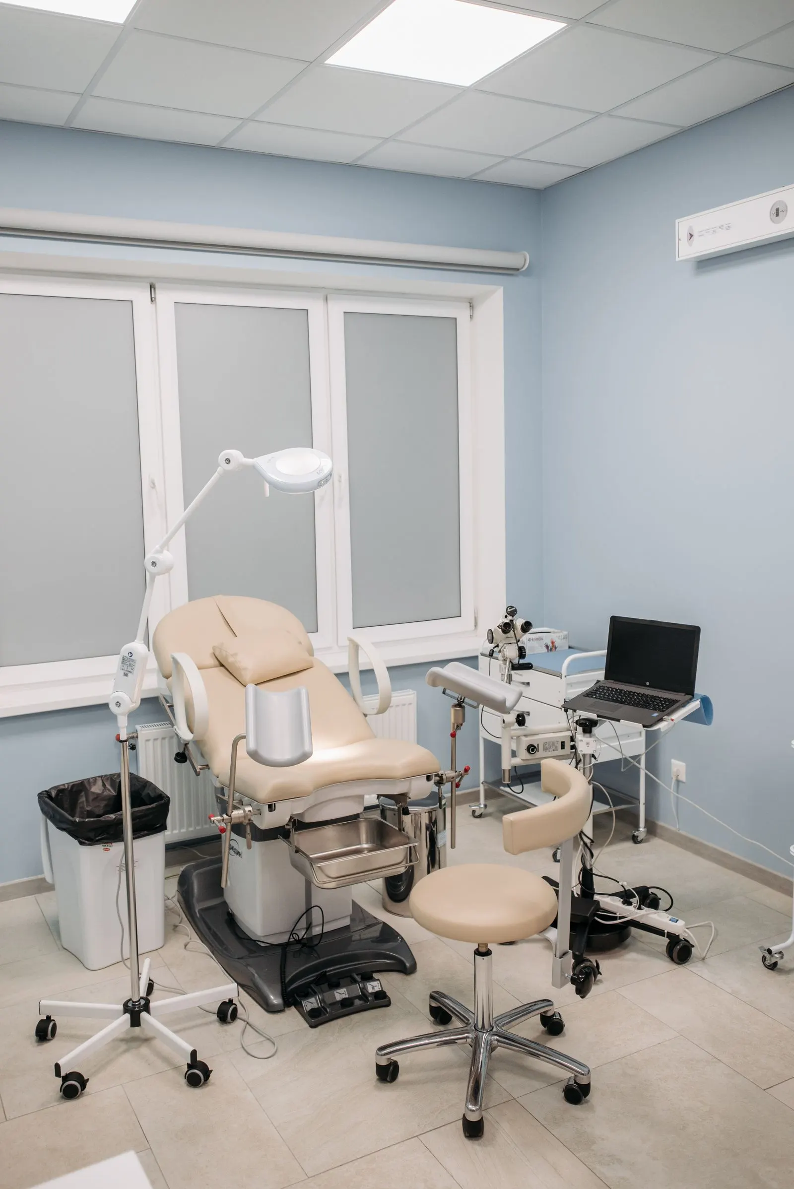 A treatment room with a chair, a lamp and nothing else in view.
