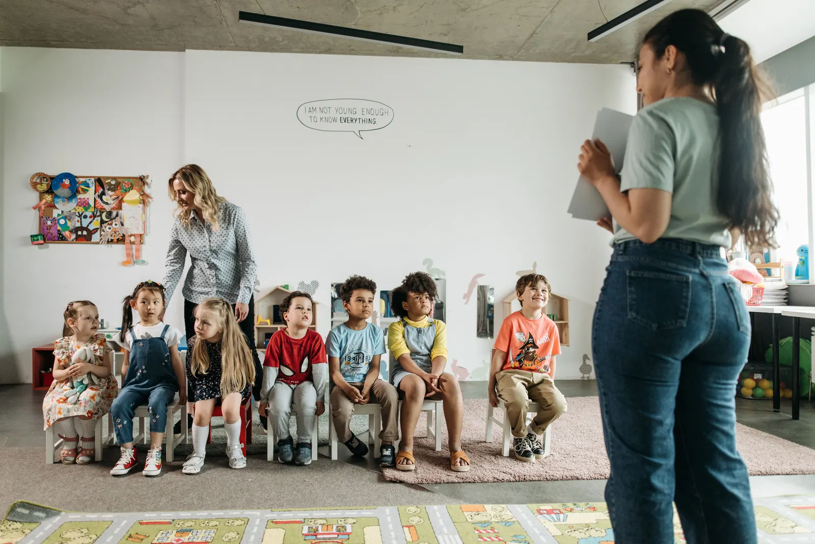 A teacher working with a small group of students around one table.