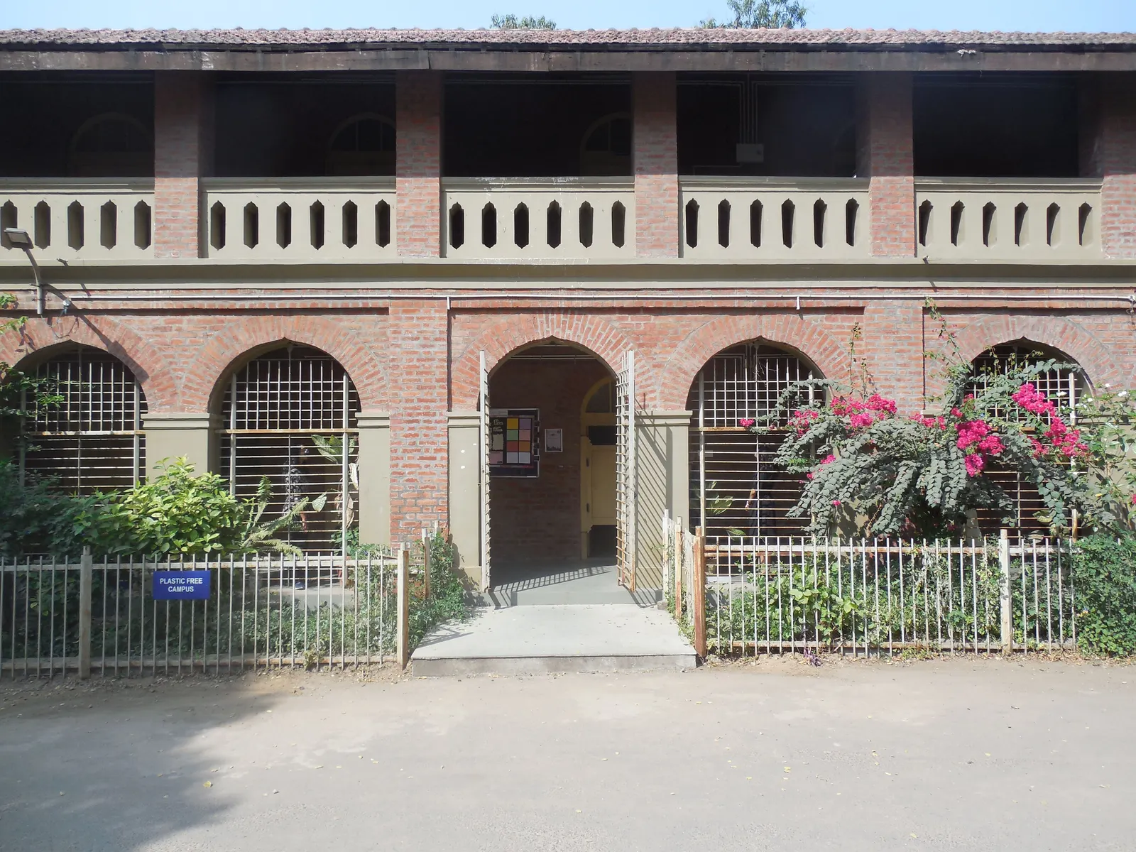 The grounds at a school entrance, photographed wide in daylight.