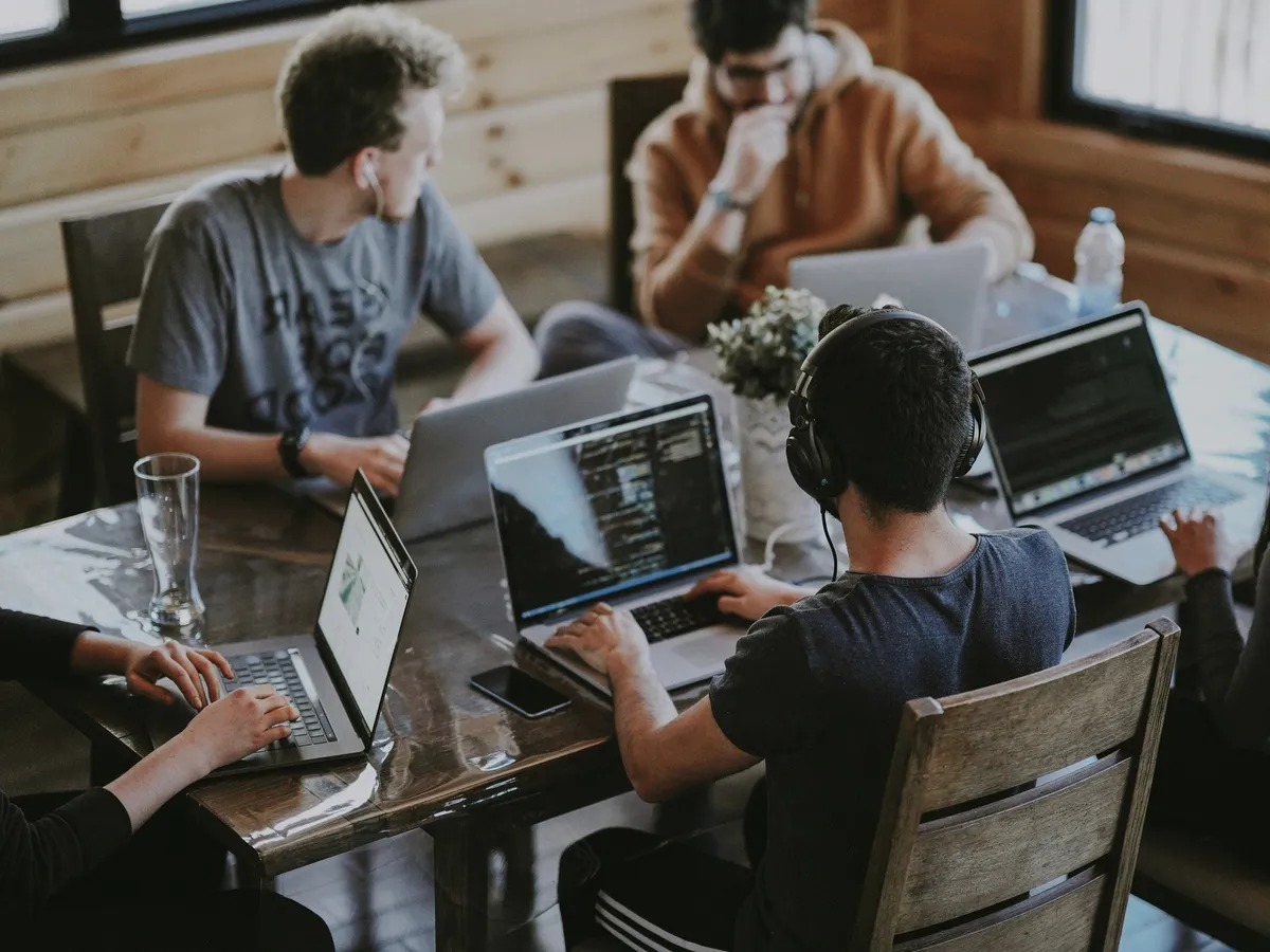 A team at laptops in a coworking space.