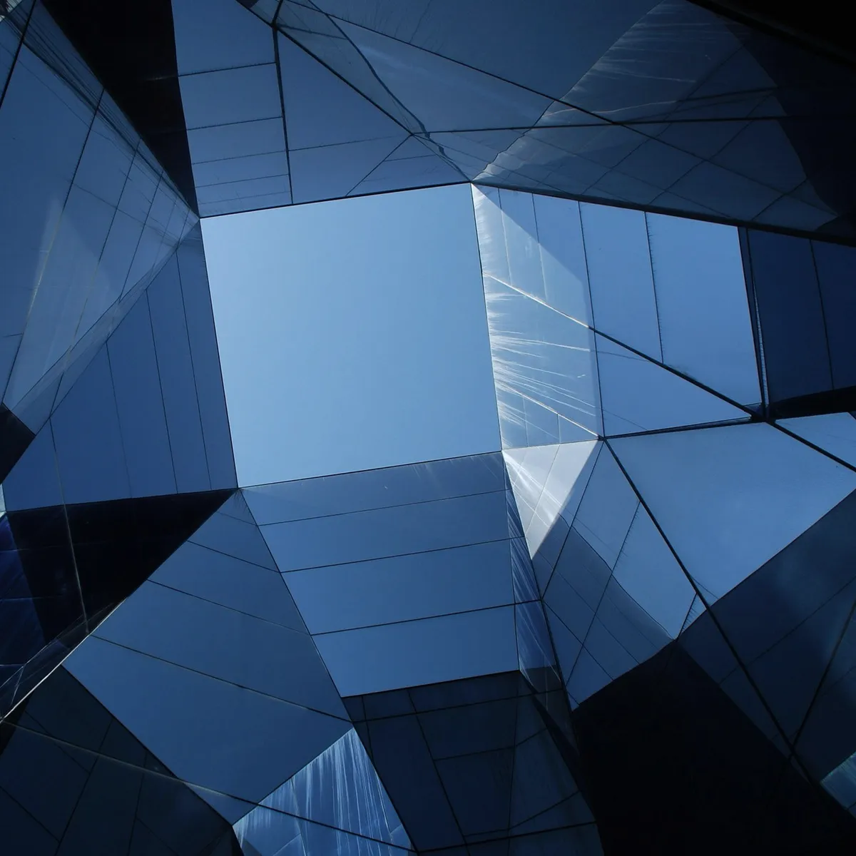 A glass building seen from below.