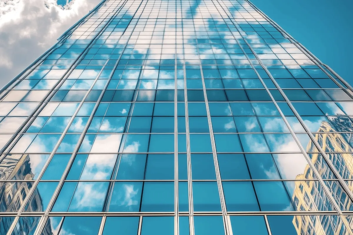 A glass tower reflecting the sky.