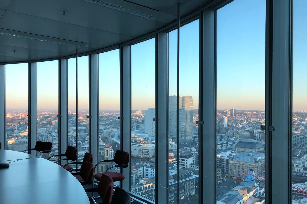 Chairs at a window over the city.