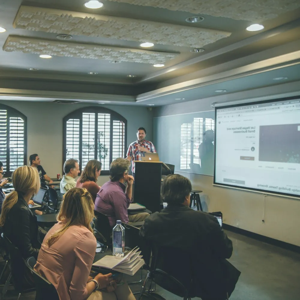 A lecture in a wood-panelled hall.