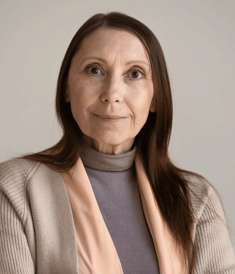 A woman in a beige jacket.