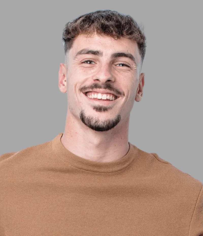 A young man in a brown top.