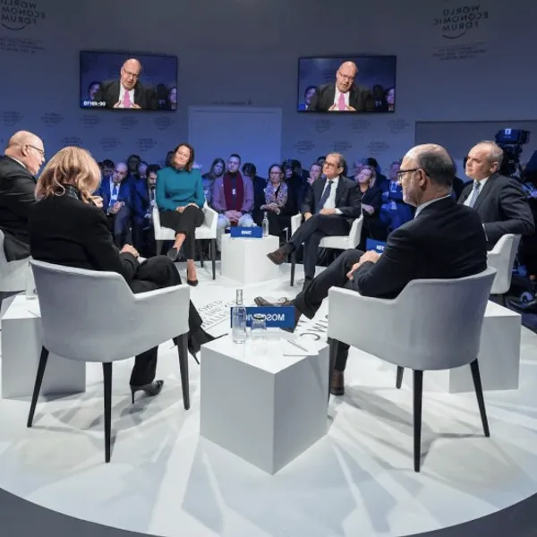 A panel discussion on a blue stage.