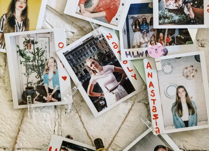 Instant photographs of guests pinned to a board.