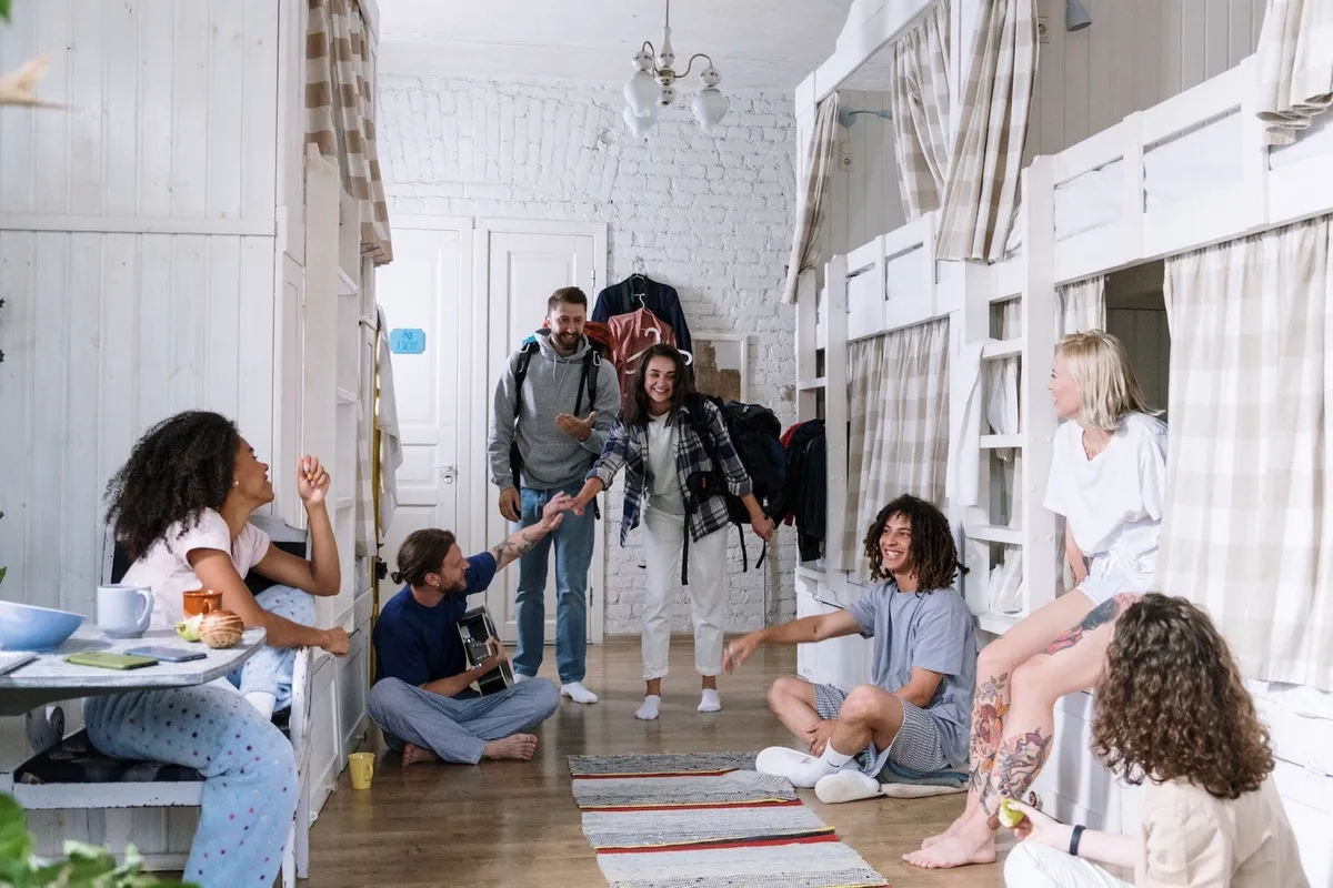 A group of friends in a dorm, laughing.