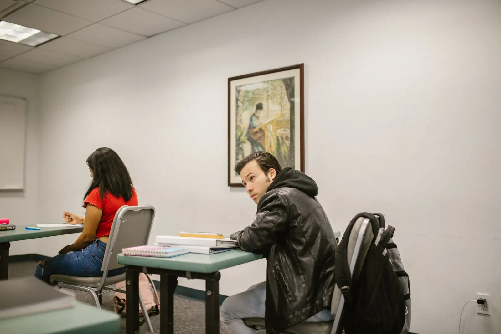 A small group class with course materials open on the table.