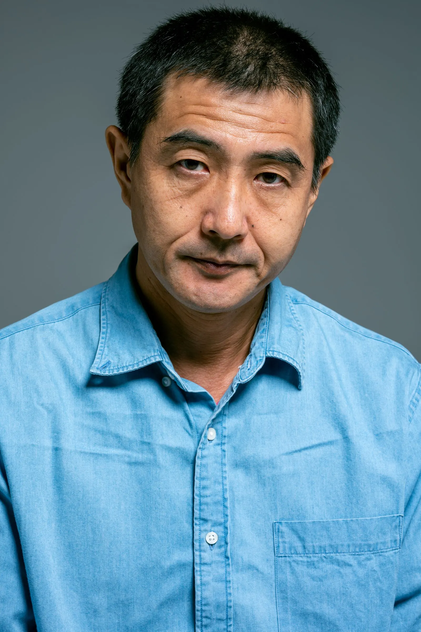 A stock portrait of a teacher against a plain background. Not a teacher at this school.