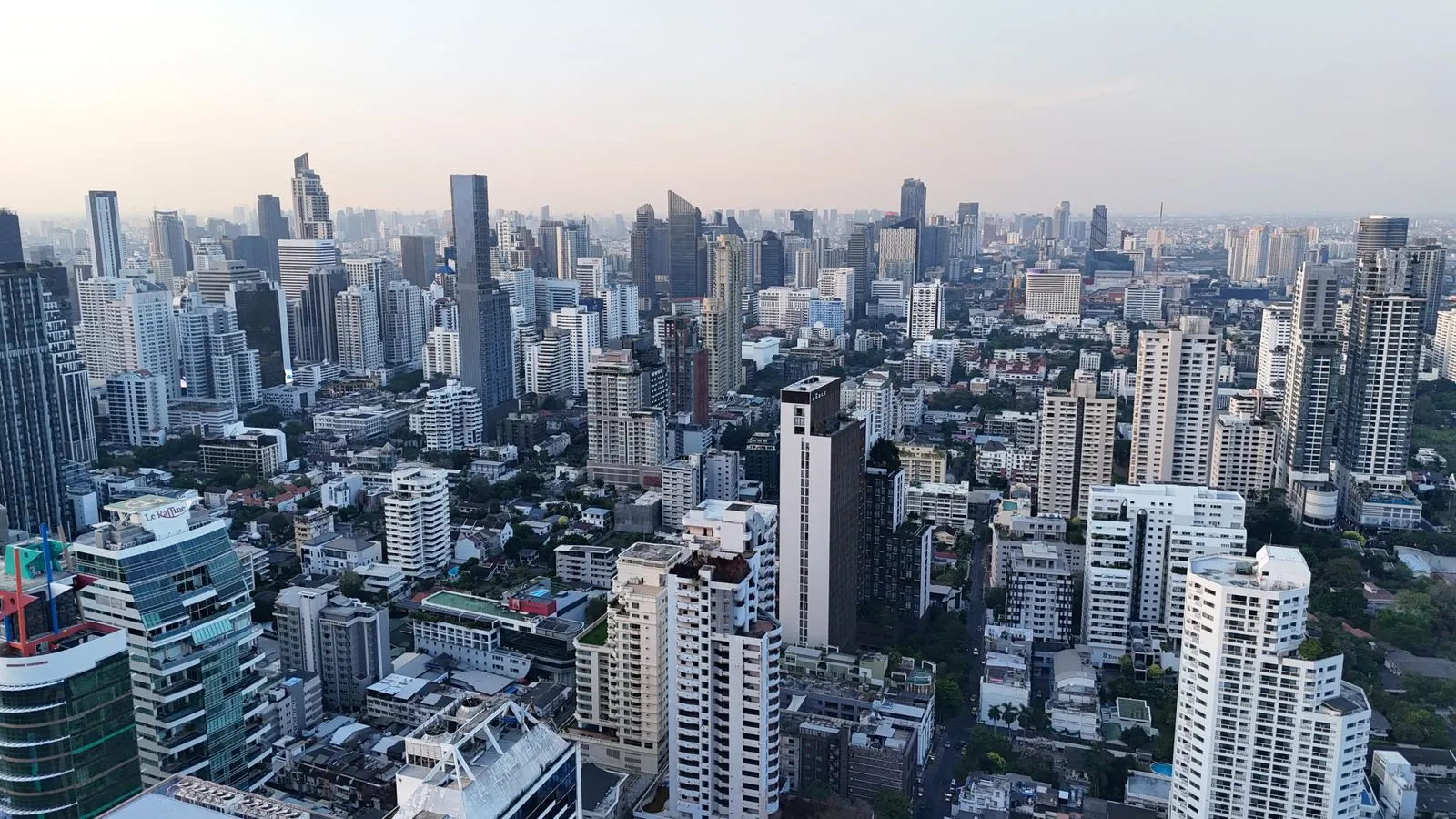 A wide aerial of a city and its river, standing in for the drawn coverage map.