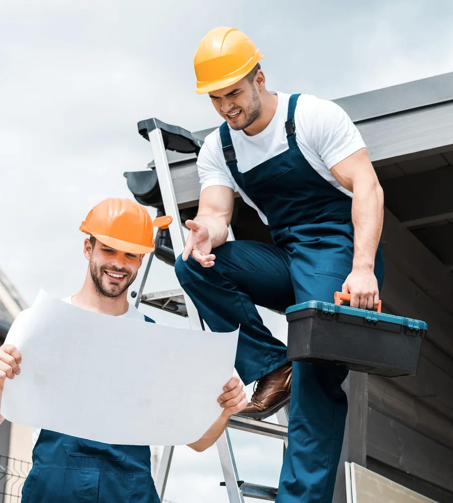 A roofer with a toolbox on a ladder.