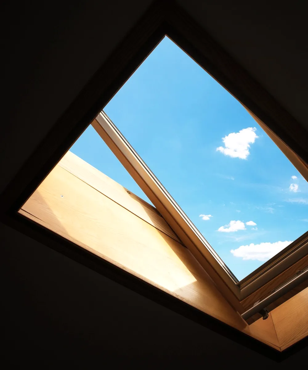 A skylight open to a blue sky.