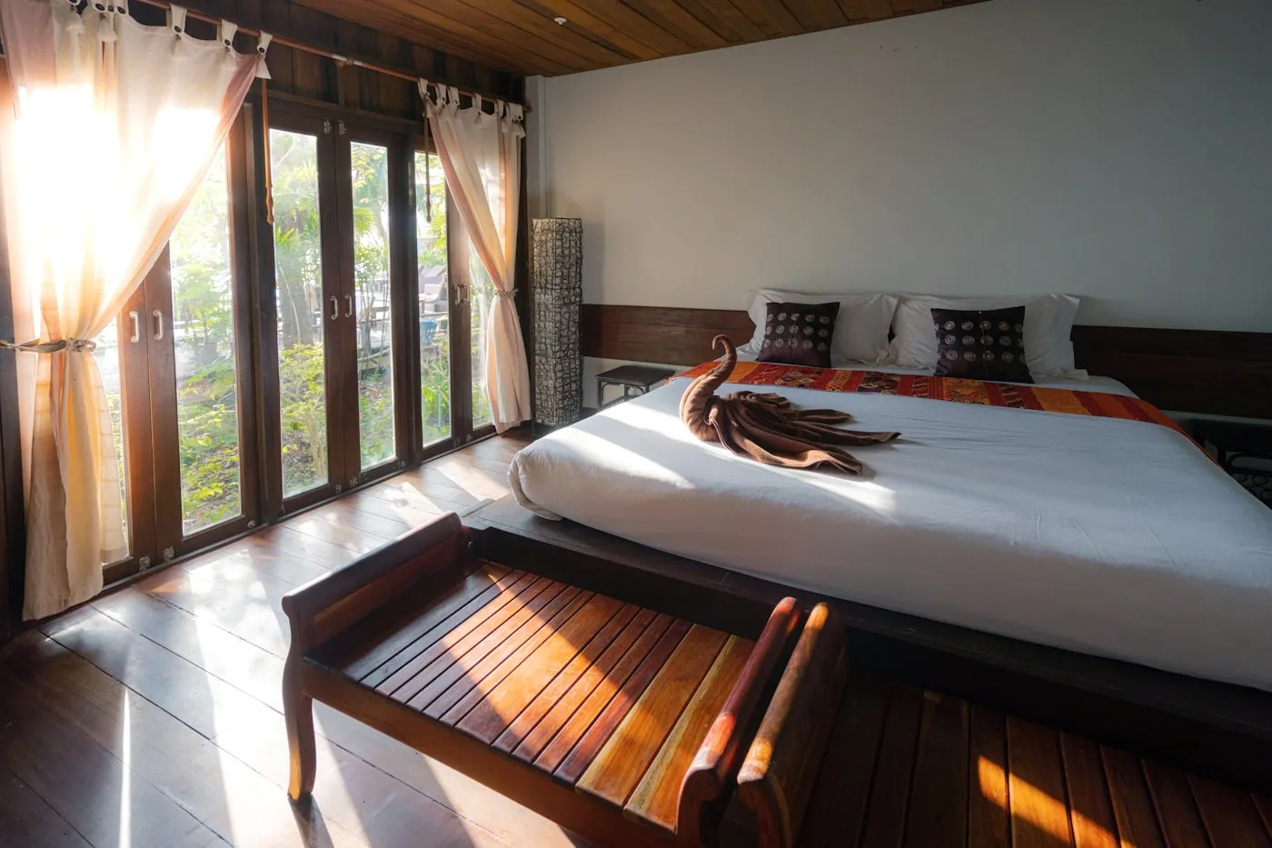 A room with wooden floors and a bright window.
