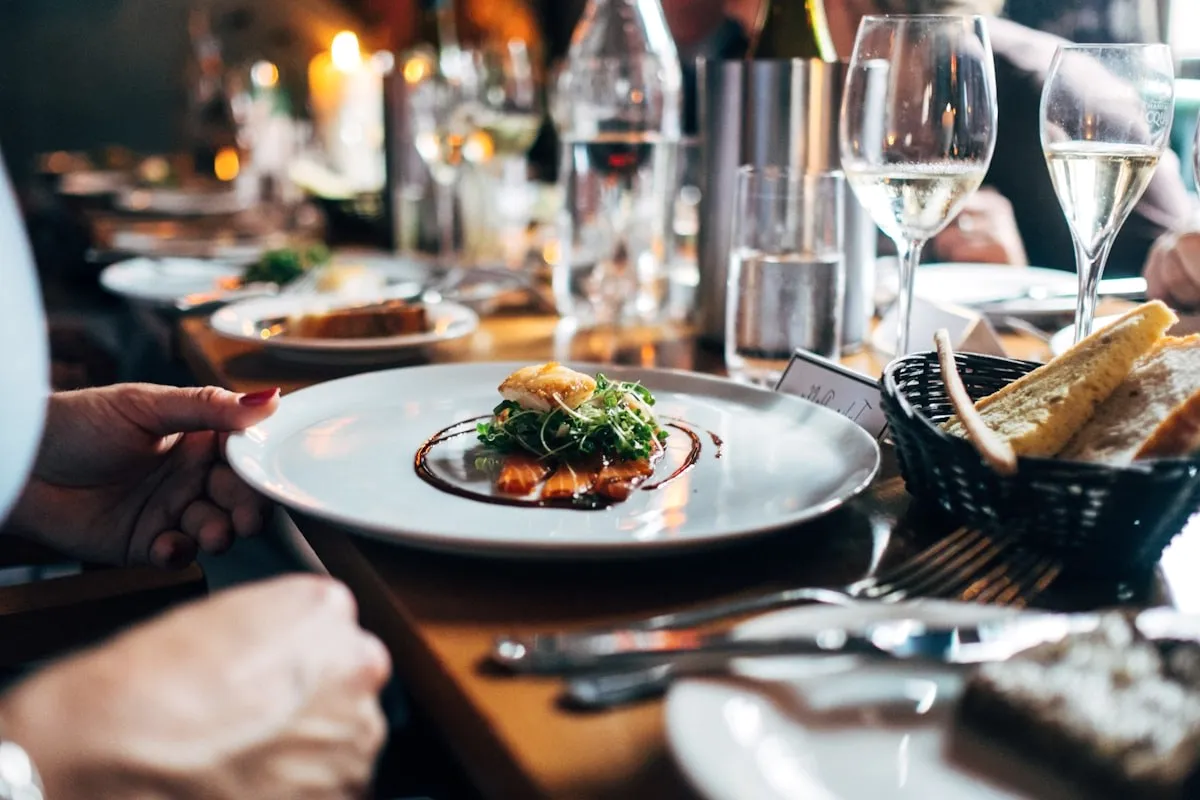 A plate being served at a set table.