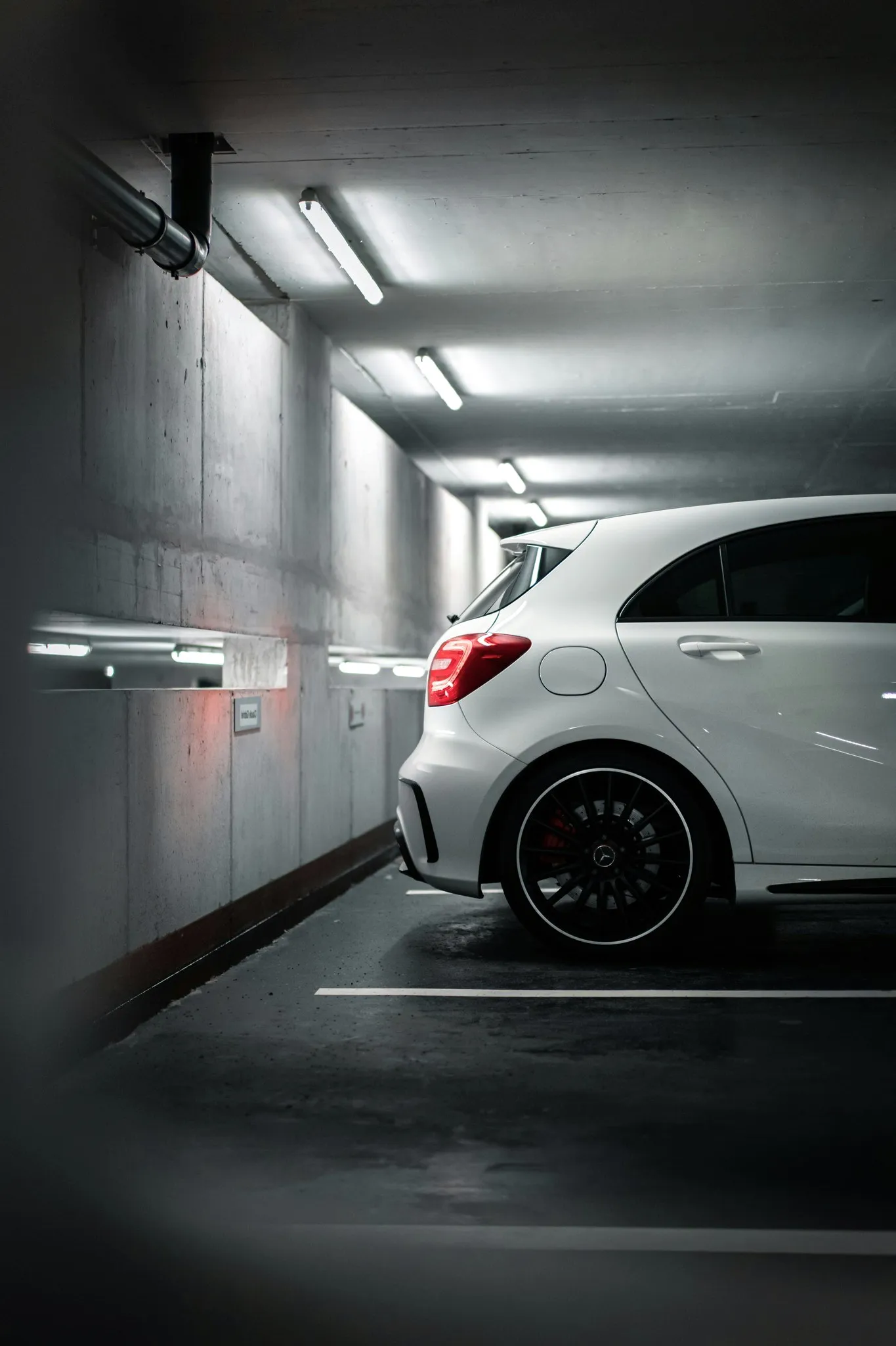 A white car in an underground garage.