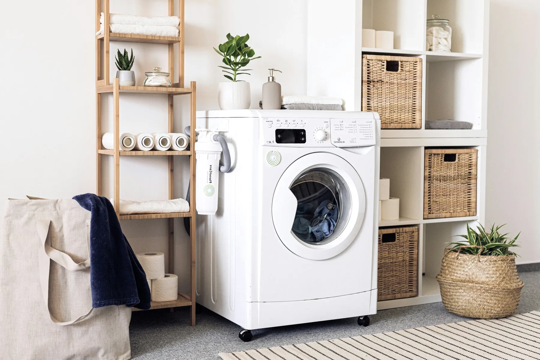 A washing machine among shelves and baskets.