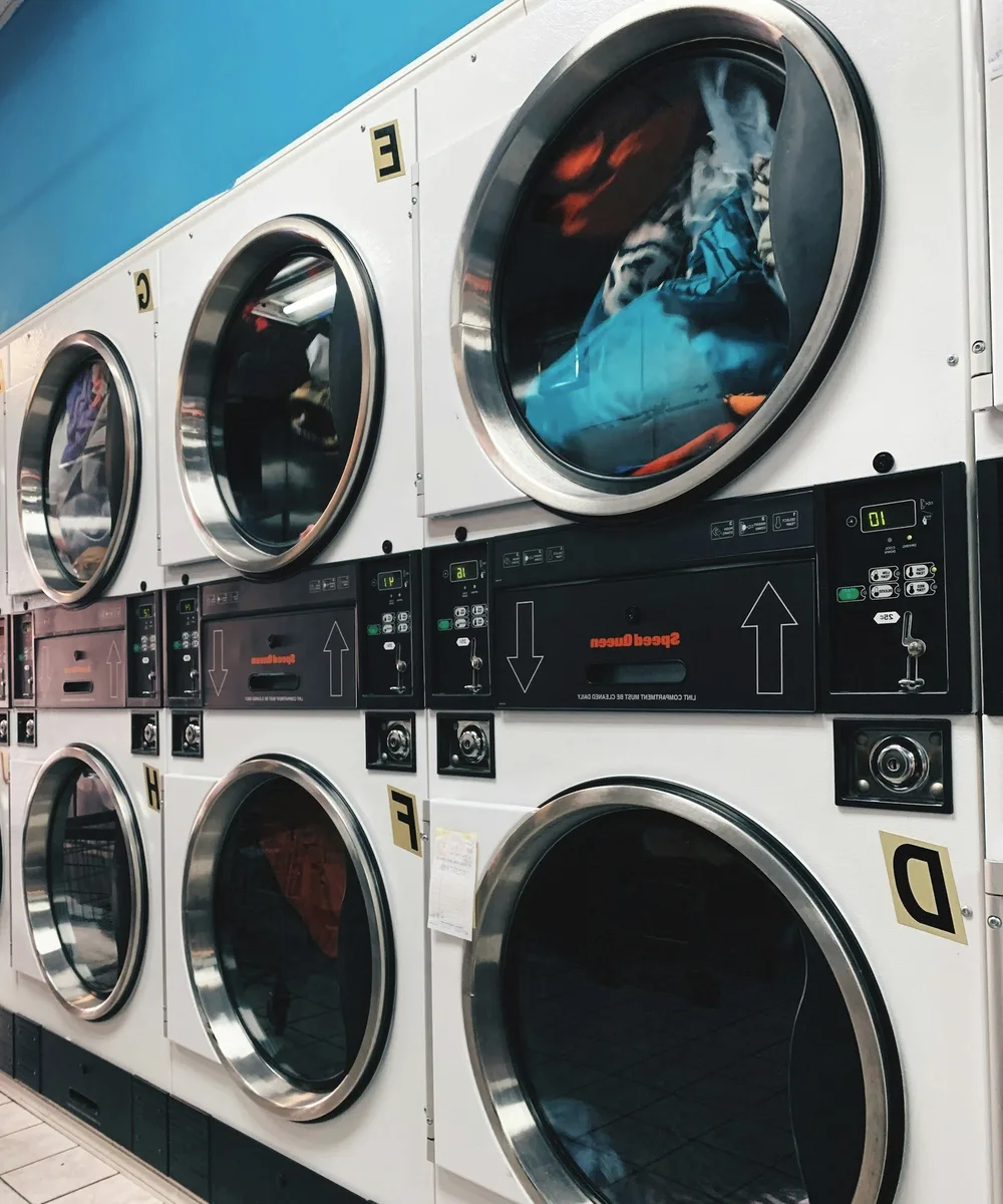 Stacked washing machines in a laundrette.