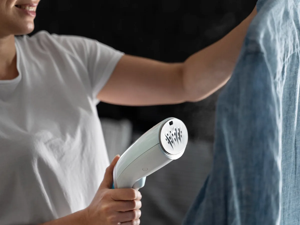 A garment steamer on a shirt.