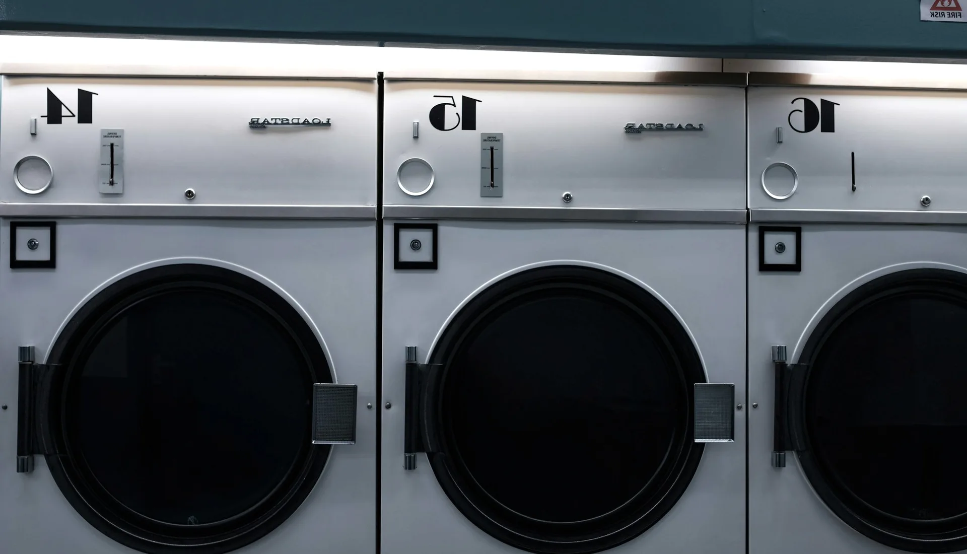 Numbered washing machines in a laundrette.