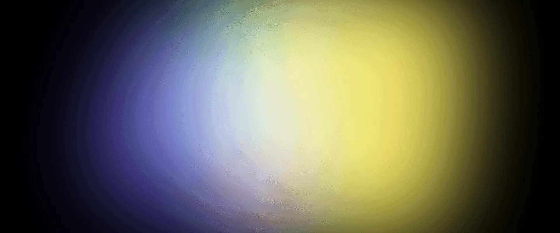 A soft yellow and blue glow on black.