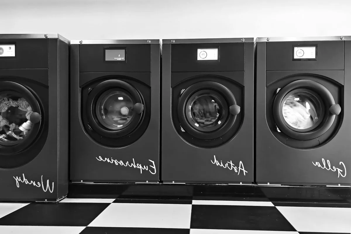 A row of black commercial washers.