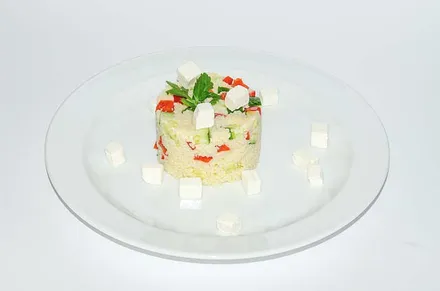 A small tower of diced vegetables on a white plate.