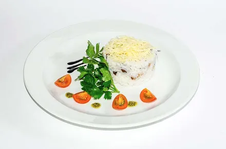 A plated starter with herbs and tomatoes.